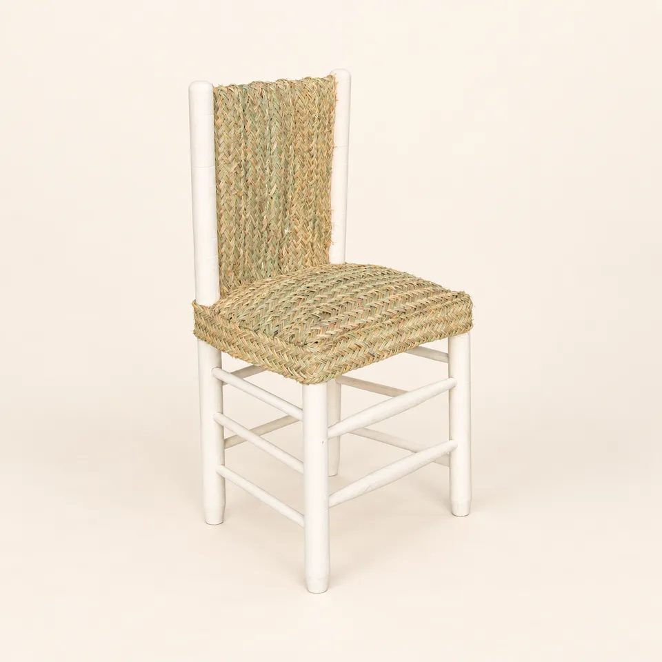 Silla artesanal de esparto y madera sobre fondo claro